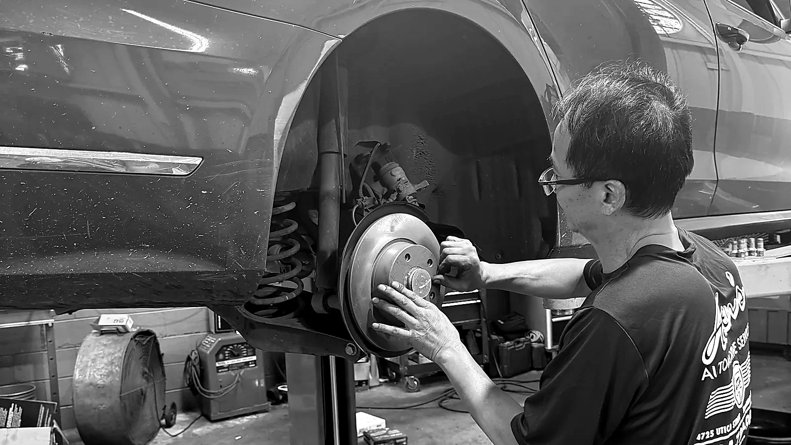 Allen’s Automotive mechanic servicing the exposed rear brake rotor on a car